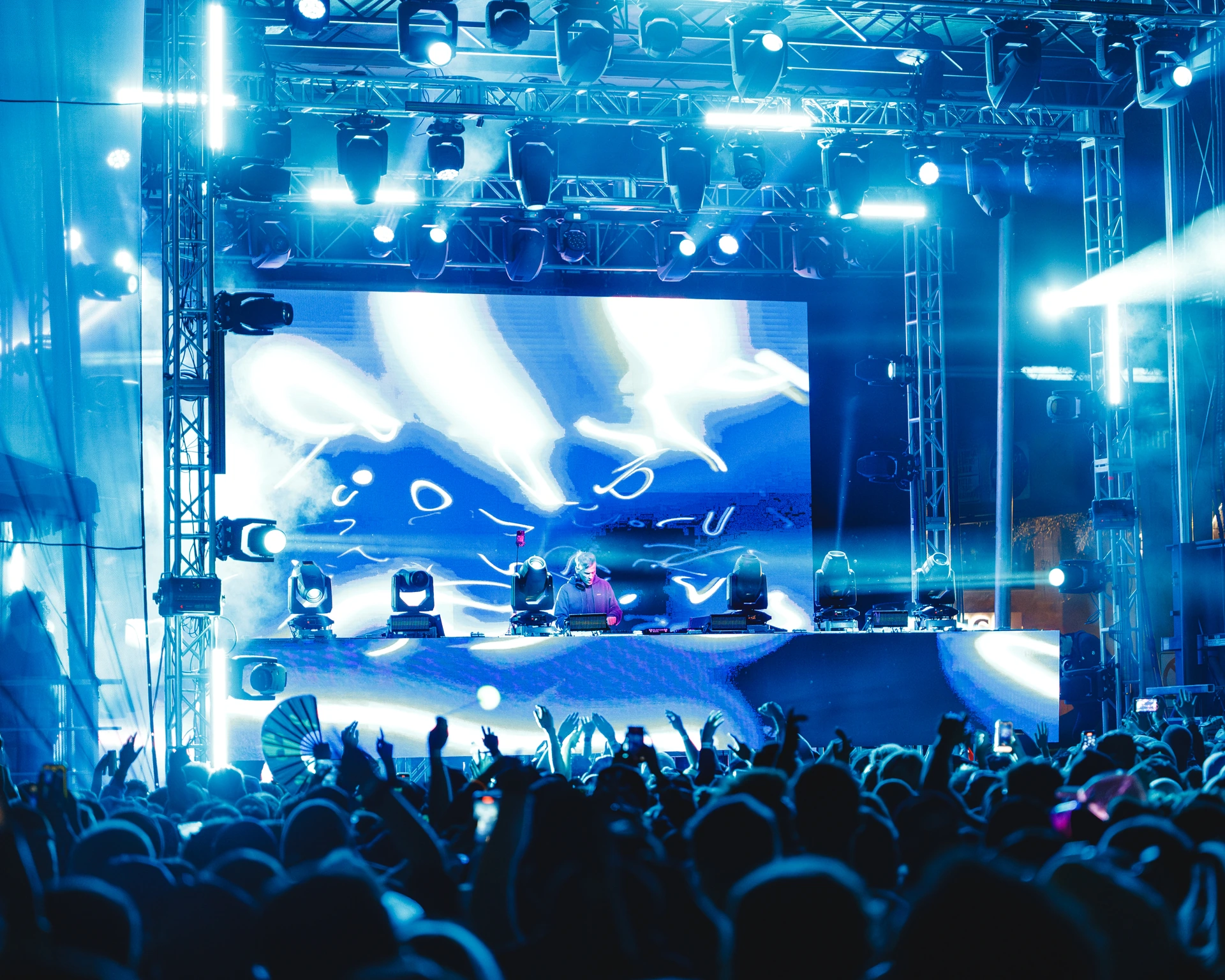 Blue stage lights above the DUSK festival crowd