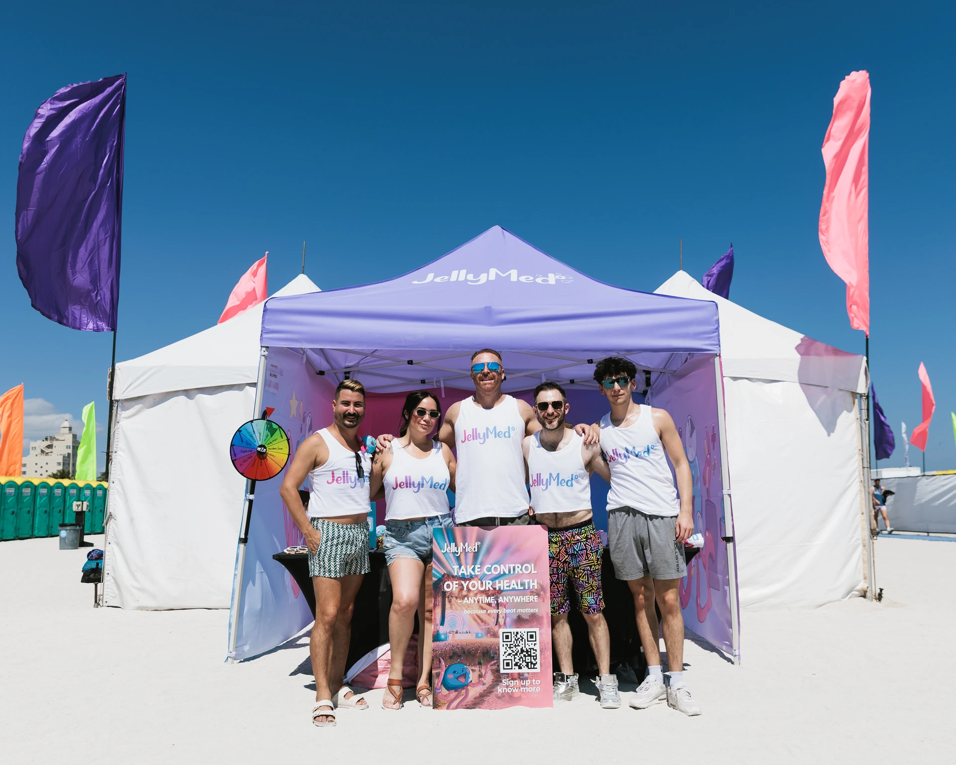 The JellyMed team outside the purple tent at Winter Party