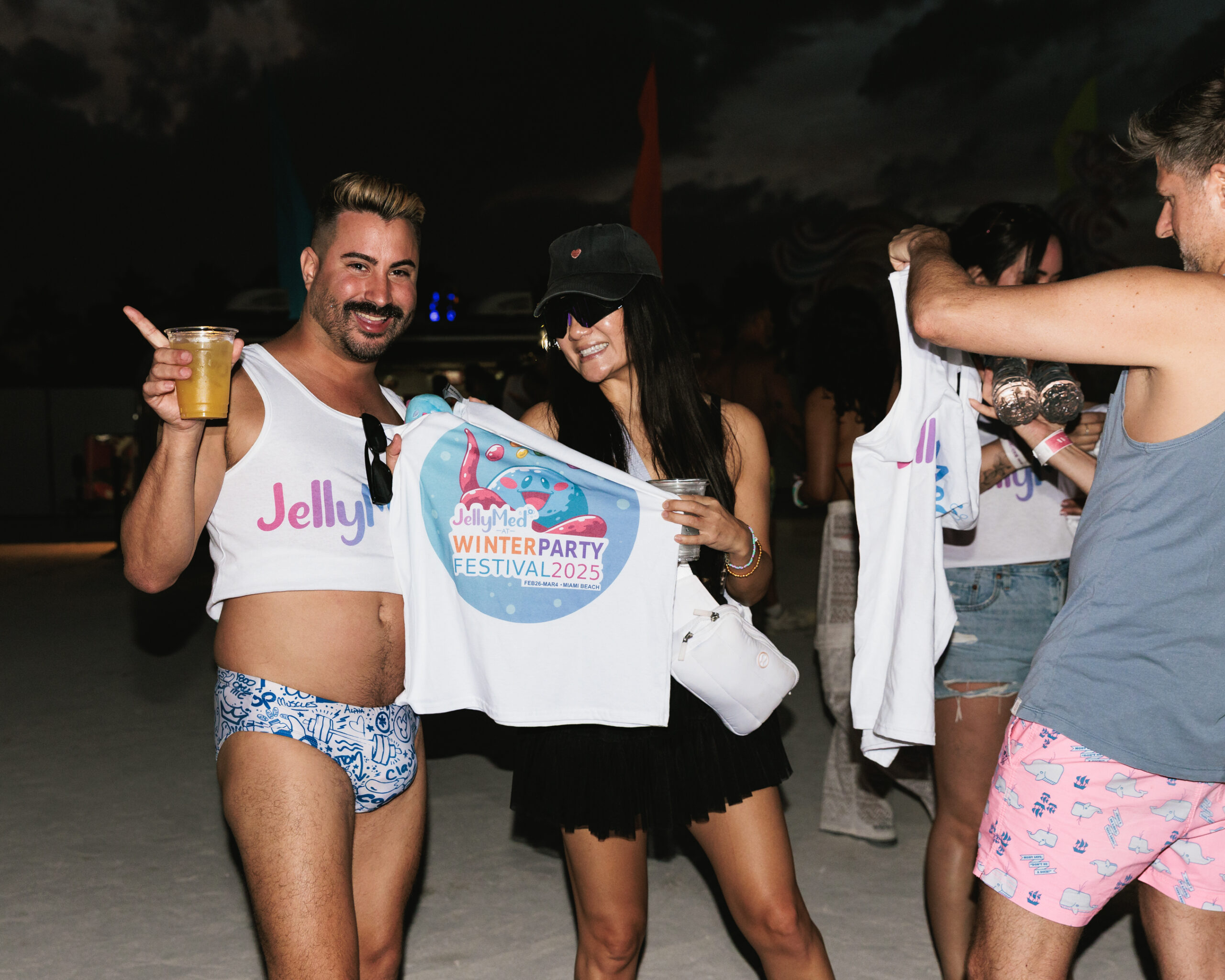 Guests holding JellyMed gear at Winter Party